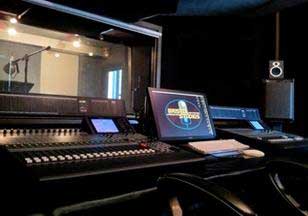 Sound editing room with all the bells and whistles showing in the background a recording room Sound Edition Room
